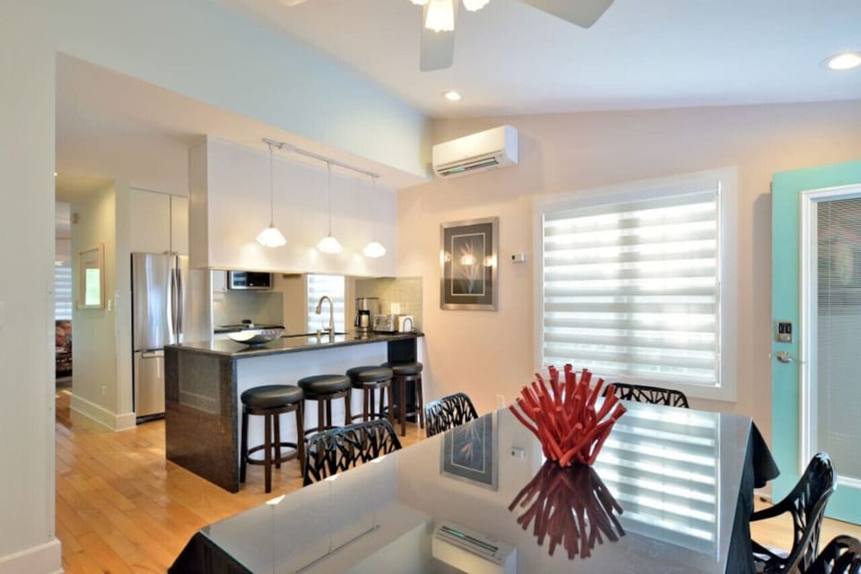 View of kitchen with breakfast bar/stools from dining room.