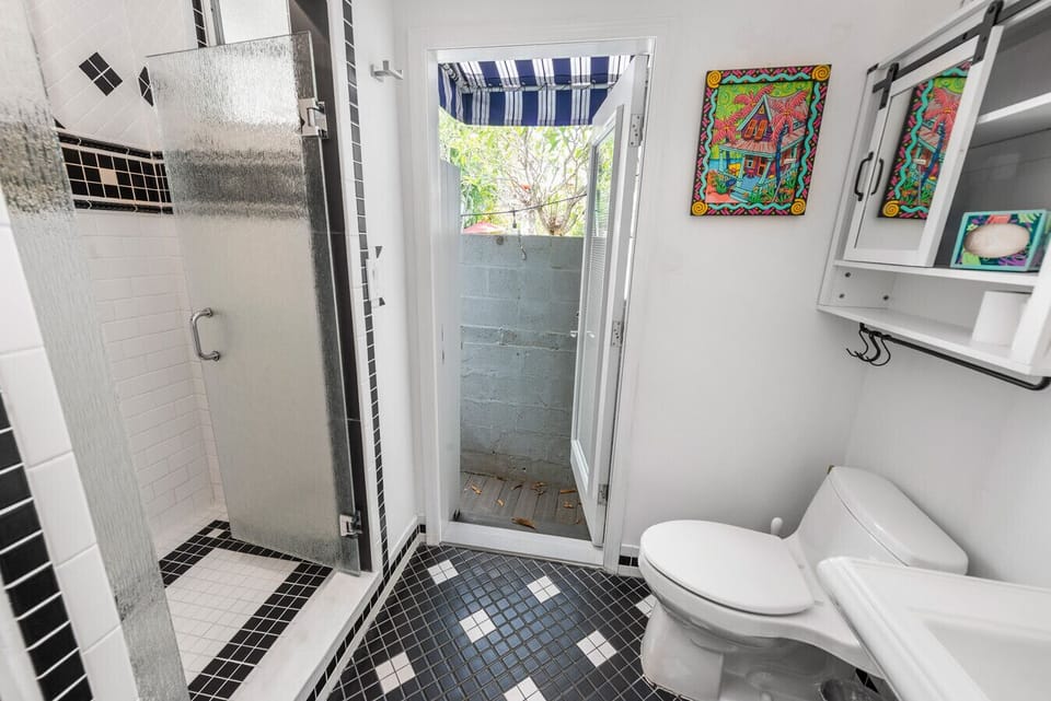 Custom shower in downstairs bathroom and door leading to private outdoor shower.