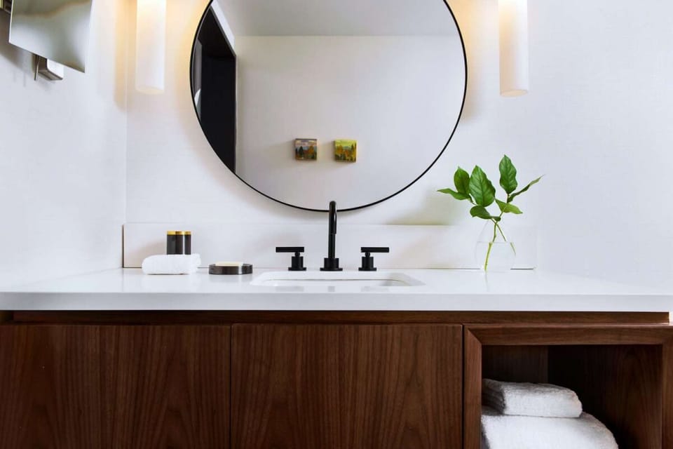Refresh effortlessly at a bright vanity with modern matte fixtures.