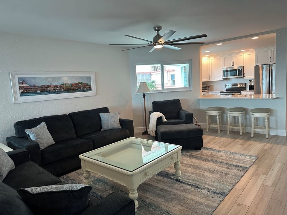 Living Room with two full couches and a chair with ottoman