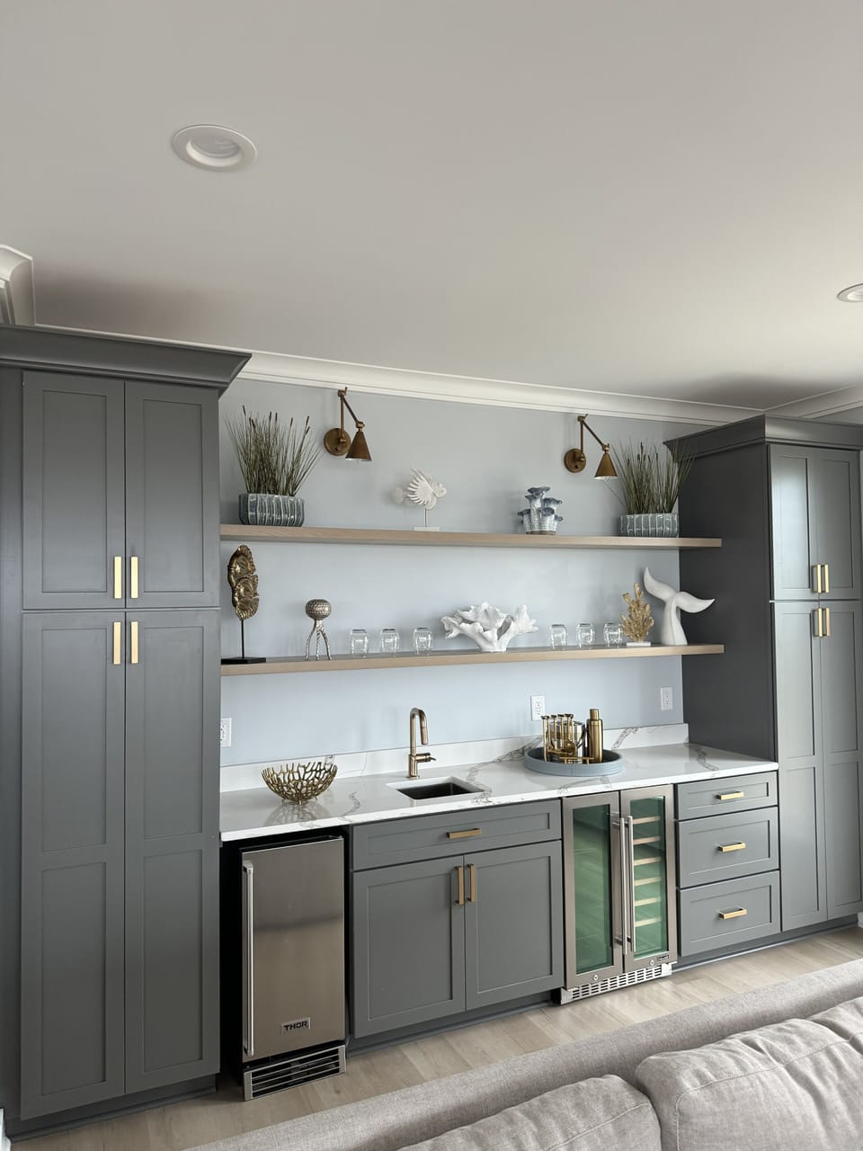 Wet bar with a wine cooler and ice maker. 