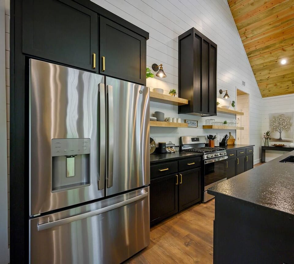 Large refrigerator and freezer complete with water and ice in the door.