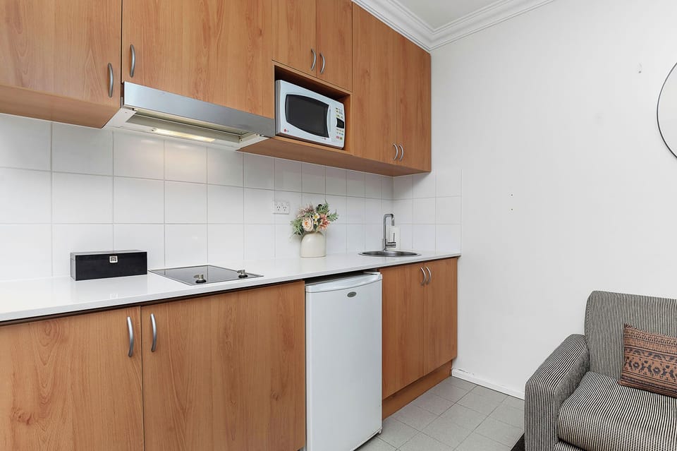 Whip up a delicious meal in this modern kitchenette, equipped with everything you need to cook up a storm.