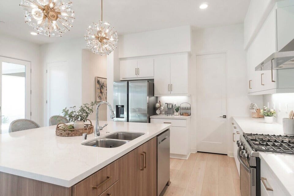 This kitchen features an abundance of lighting and bar-height dining,