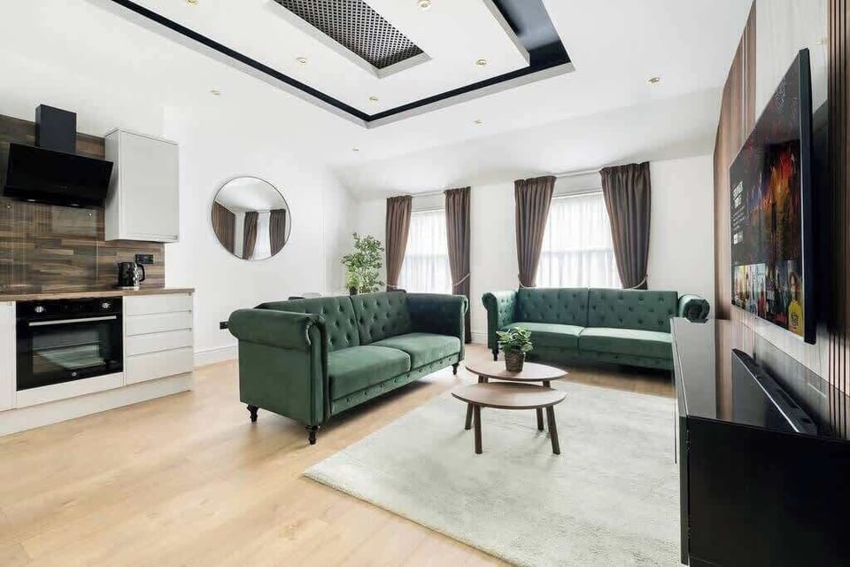 Living Room | Relax in sheer luxury within a beautifully designed living room, featuring wooden panels, marble walls, and ambient LED lighting. This super spacious sanctuary is adorned with a 70-inch smart TV and equipped with air conditioning.