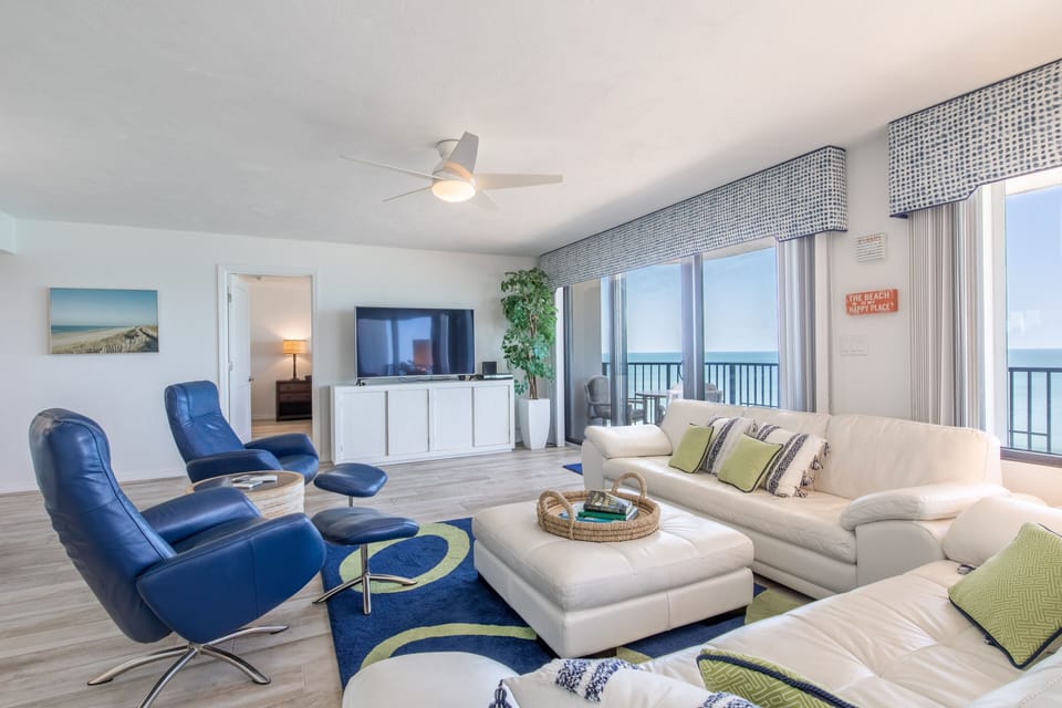 Spacious and comfortable oceanfront living area open to private balcony.