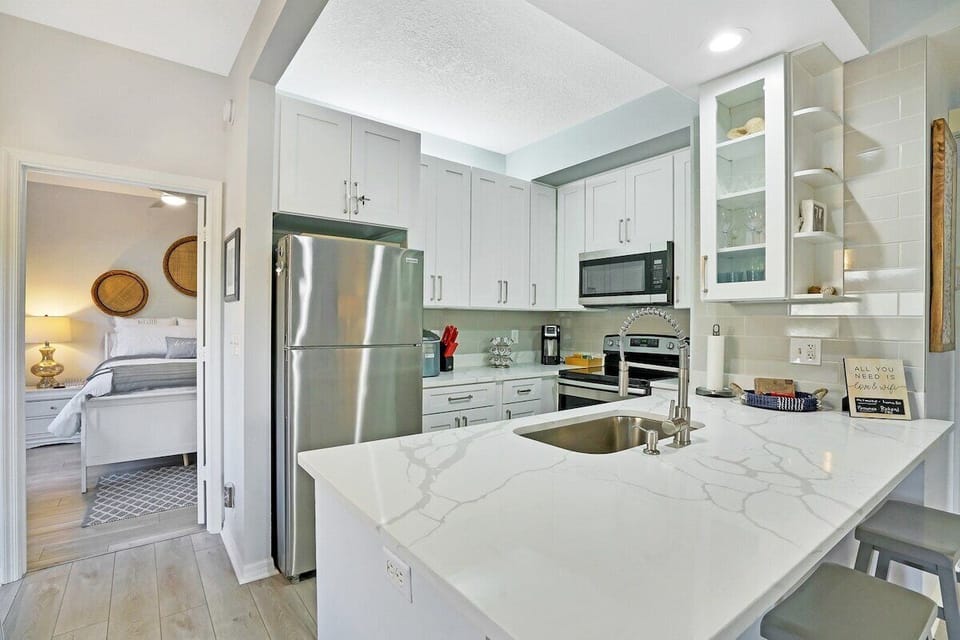 Newly renovated kitchen with stainless steel appliances, fully stocked with everything you need to cook and dine in comfort during your stay.