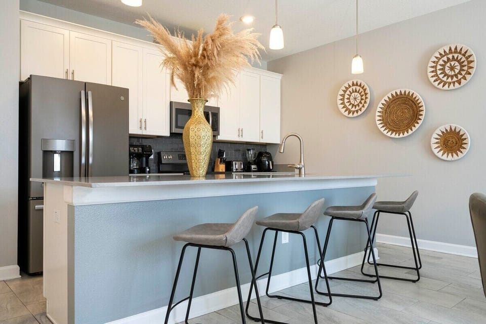 The fully equipped kitchen features modern appliances, sleek cabinetry, and all essential cookware and utensils, making it perfect for preparing meals with ease.