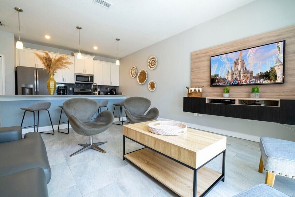 Step into this spacious, comfortable living area. The expansive room is adorned with tasteful decor, offering a blend of modern aesthetics and homey warmth. 