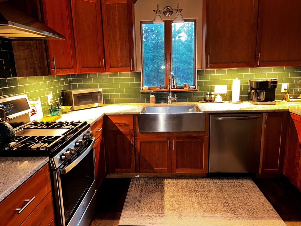 Keurig and regular coffee maker. Farmers sink. Gas stove. High-end cookware.