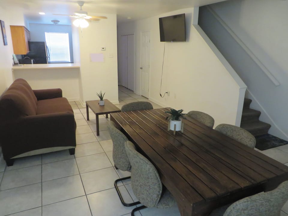 Three sofa bed couch. Large dining table with 6 seats. 50in smart TV, ceiling fa