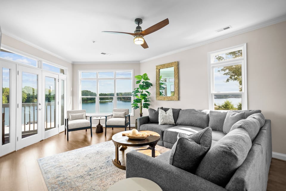 Living room with sectional, TV and amazing lake views.
