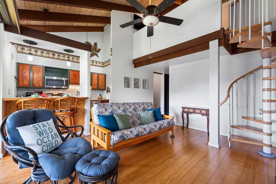 Living area with view of stairs leading to the loft