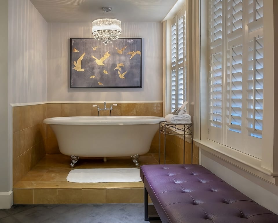 Sink into crisp linens beneath a statement headboard.