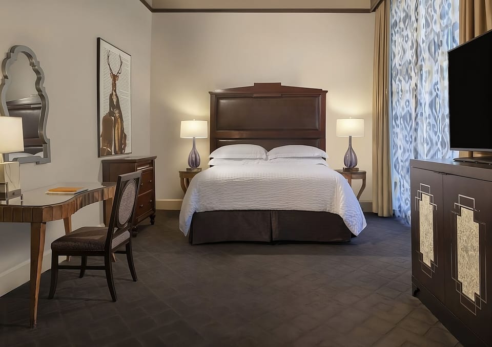 Unwind in a spacious king bedroom with warm lighting.