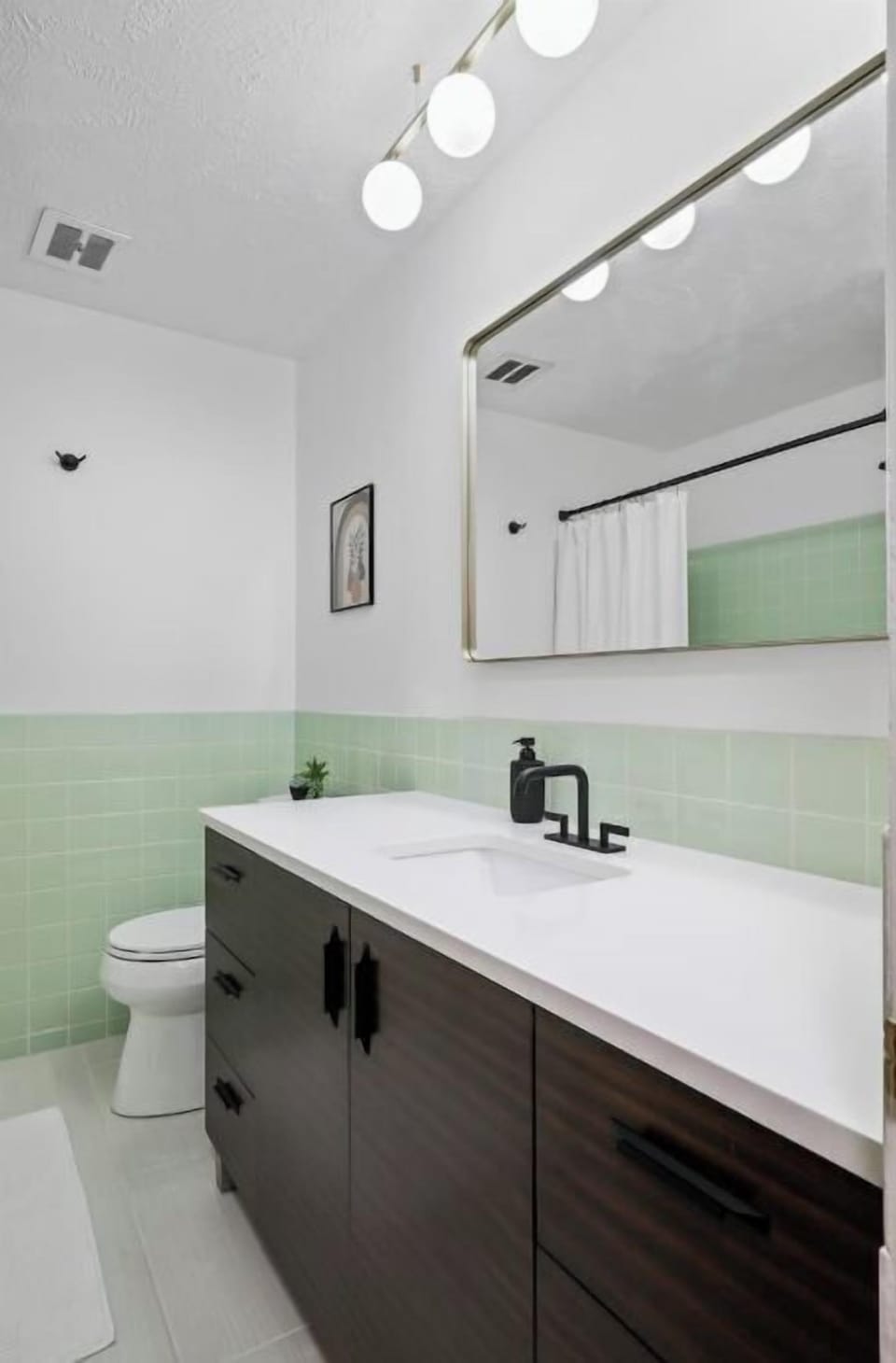 Main bathroom with large vanity and storage space