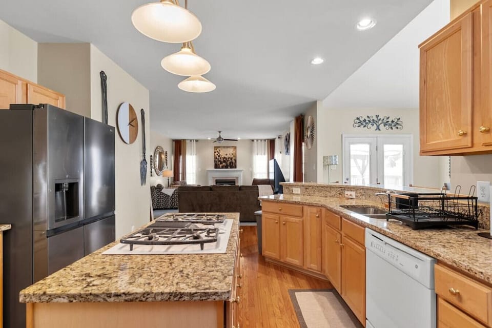This well-appointed kitchen boasts a gas stove, oven, fridge, freezer, and dishwasher. A kitchen island with a built-in stovetop provides ample prep space, while the coffee nook ensures your mornings start right!