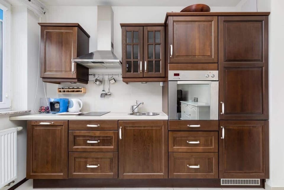 A close-up of the kitchen, showcasing its elegant wooden cabinetry and spacious countertop.
