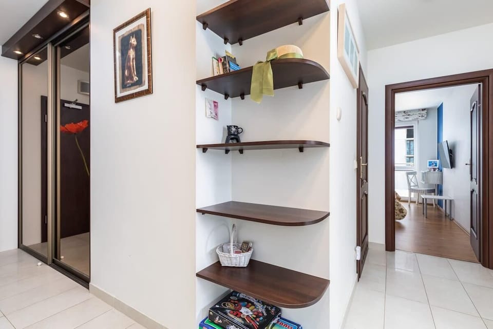 A functional hallway with built-in shelving for storage and practical organization.
