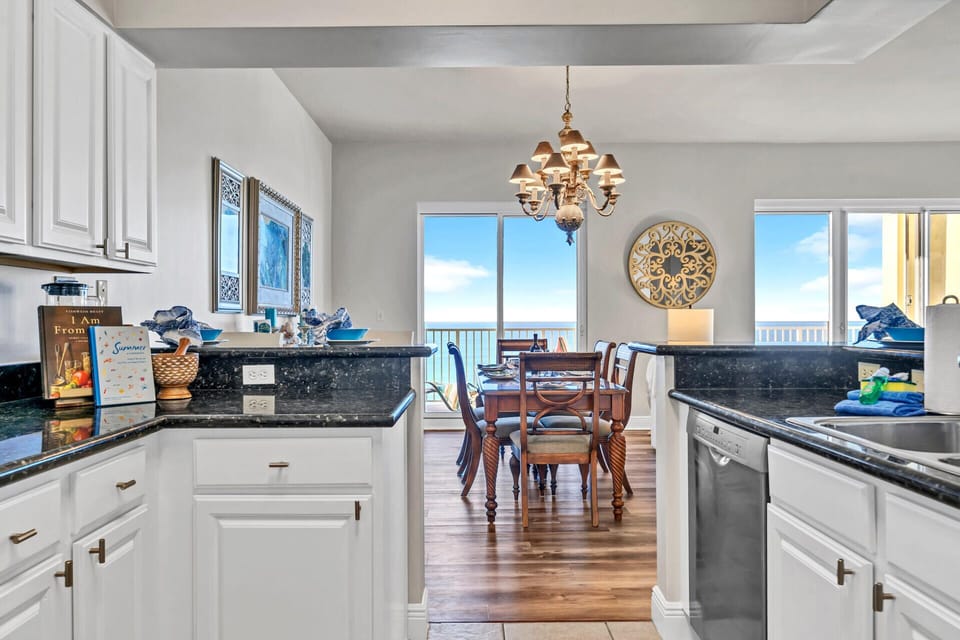 Your open kitchen flows seamlessly into the dining area, where stunning views frame every meal through floor-to-ceiling windows.