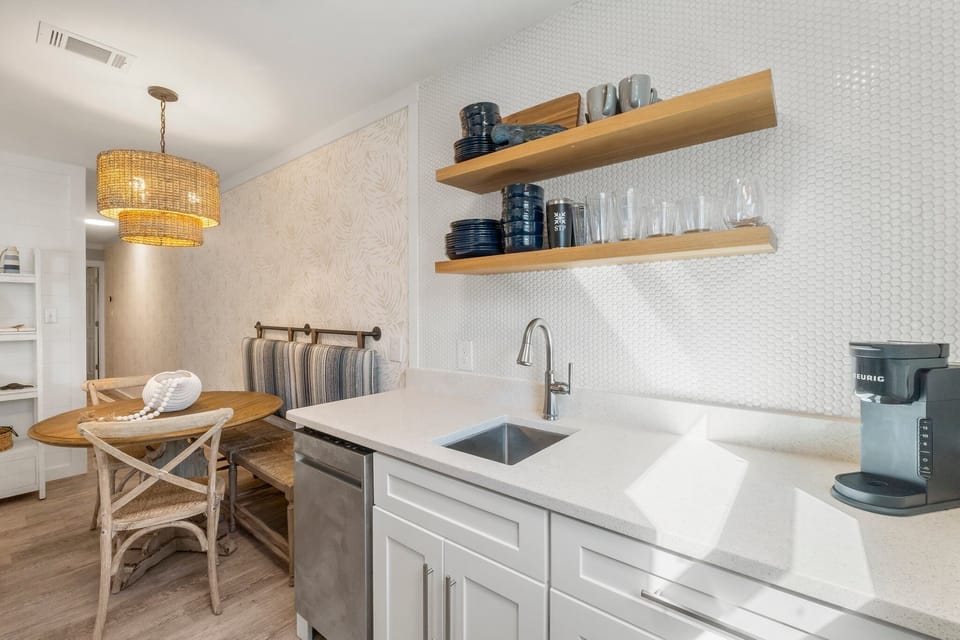 modern kitchen area with open shelving and a cozy dining nook
