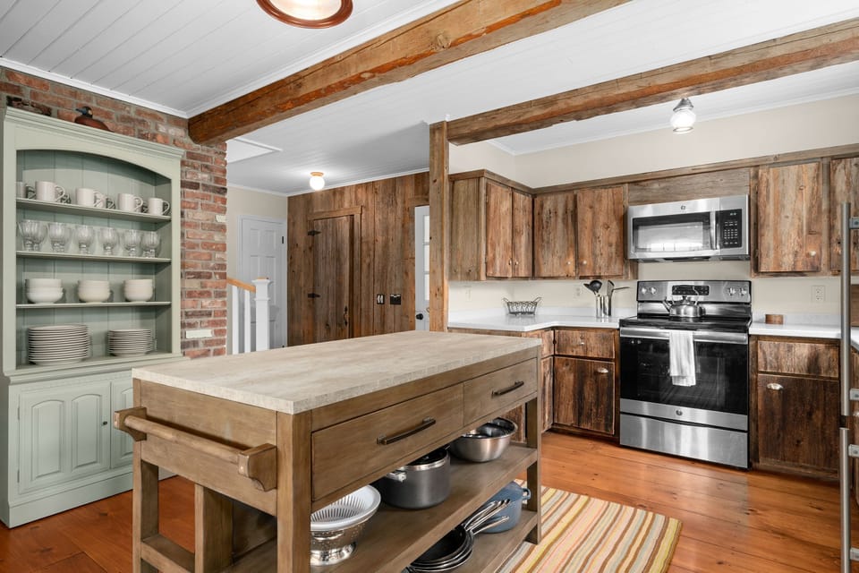 Kitchen with ample workspace and island with two stools