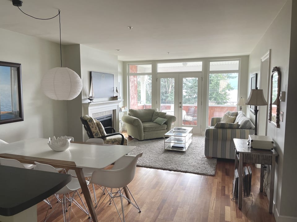Light-filled living room with record player and Bose bluetooth speaker