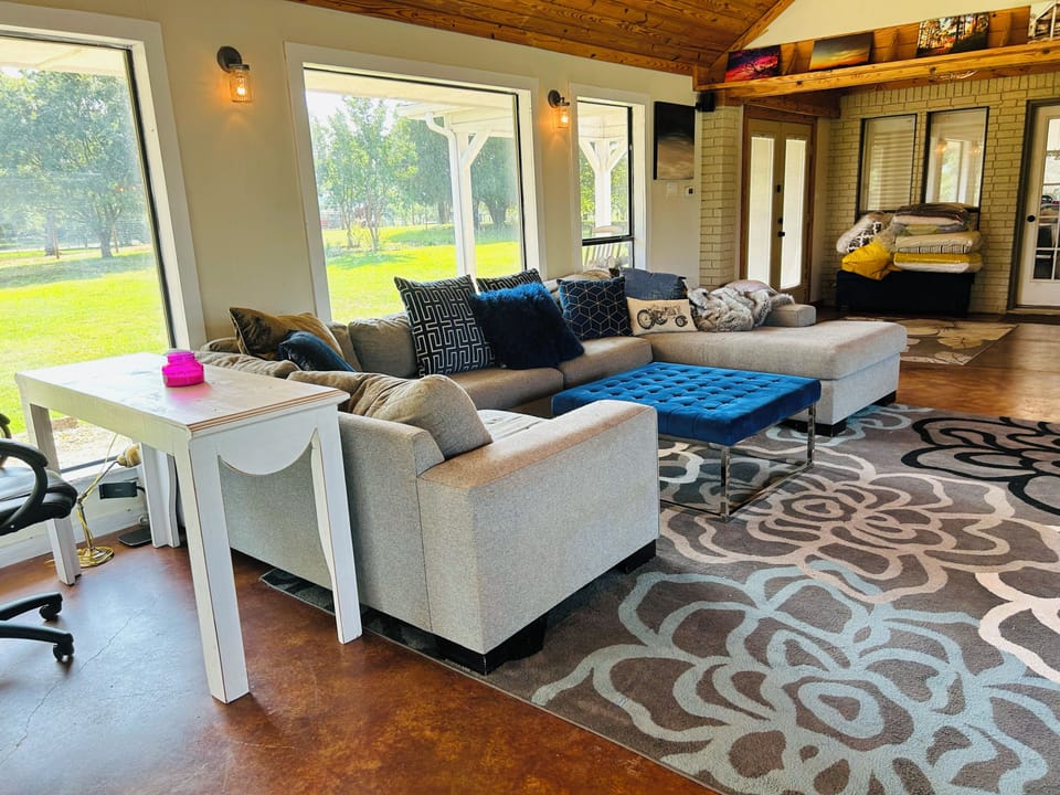 Family living with sun room with gorgeous views of pool, pastures and barn!