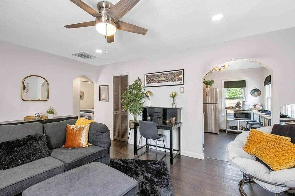 Well appointed living room with cozy sectional, 50" Smart TV and desk