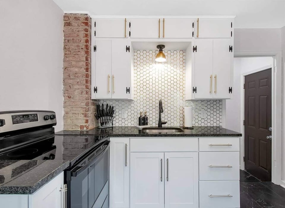 Updated kitchen with gorgeous backsplash, granite countertop and new appliances