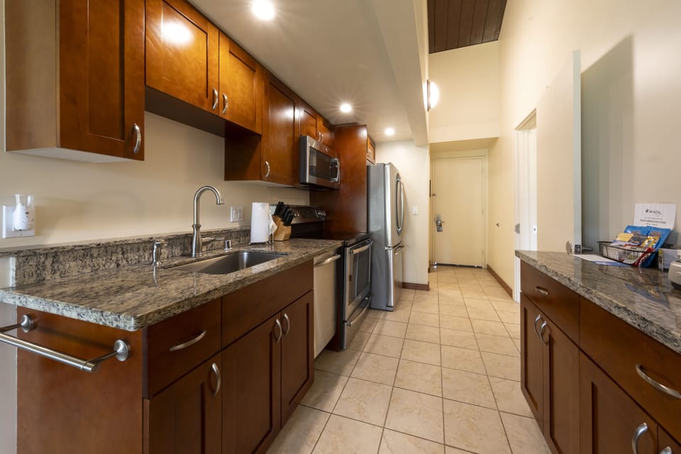 Prep island-style with granite counters and handy cookware setup.