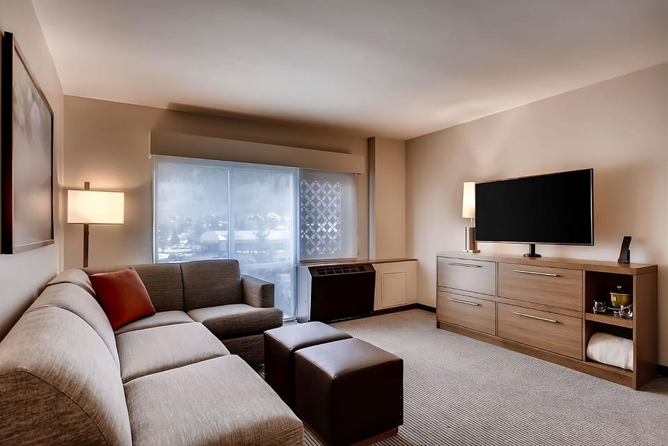 Lounge comfortably with a roomy sofa and entertainment-ready TV.