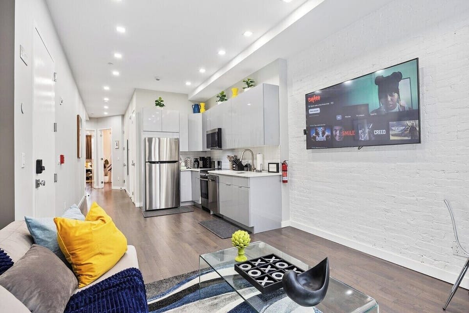 Experience seamless elegance and open-concept living in this captivating view, where the living room, dining table, and kitchen intertwine to create a space of modern comfort and effortless style.