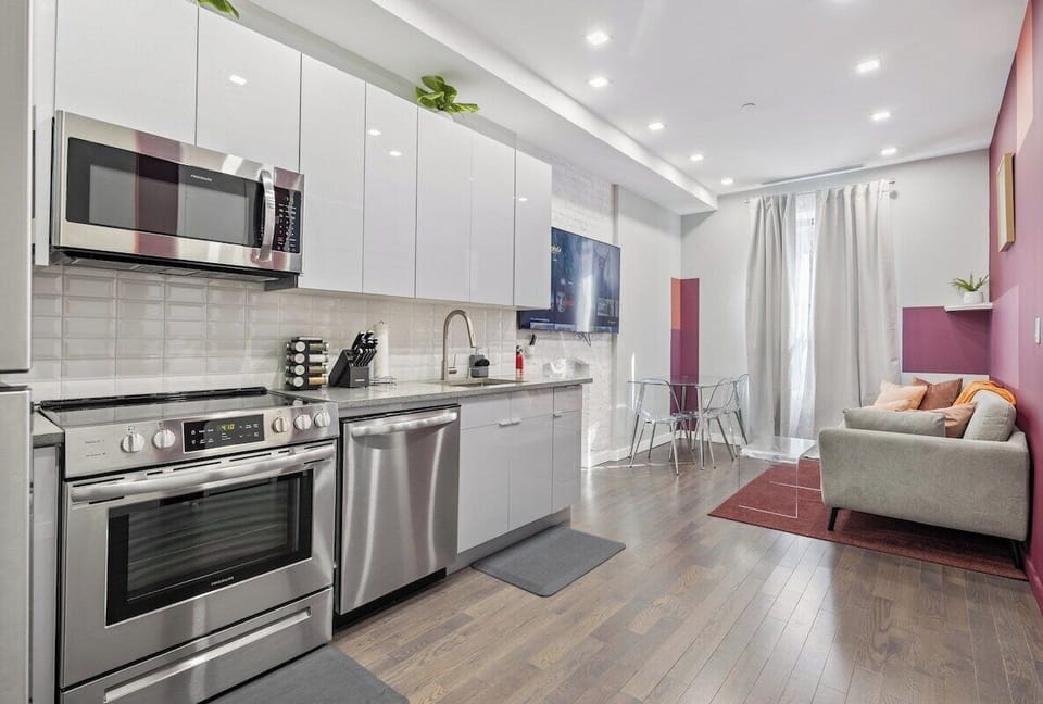 Experience seamless elegance and open-concept living in this captivating view, where the living room, dining table, and kitchen intertwine to create a space of modern comfort and effortless style.