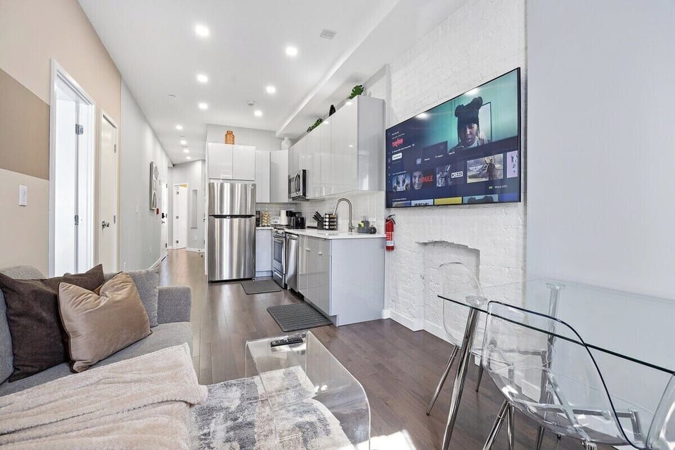 Experience seamless elegance and open-concept living in this captivating view, where the living room, dining table, and kitchen intertwine to create a space of modern comfort and effortless style.