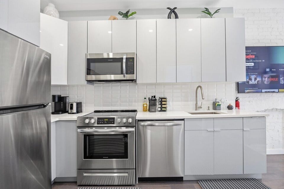 Prepare culinary masterpieces in this sleek and fully-equipped kitchen, where inspiration and flavors come to life.