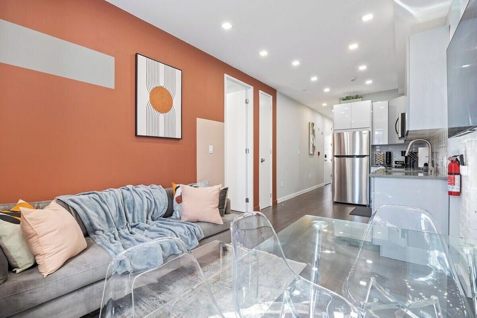 Experience seamless elegance and open-concept living in this captivating view, where the living room, dining table, and kitchen intertwine to create a space of modern comfort and effortless style.