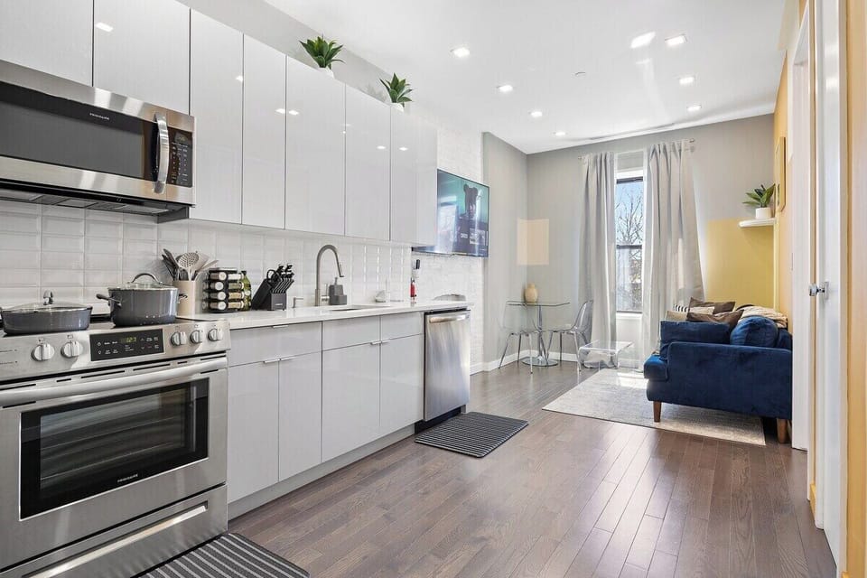 Experience seamless elegance and open-concept living in this captivating view, where the living room, dining table, and kitchen intertwine to create a space of modern comfort and effortless style.