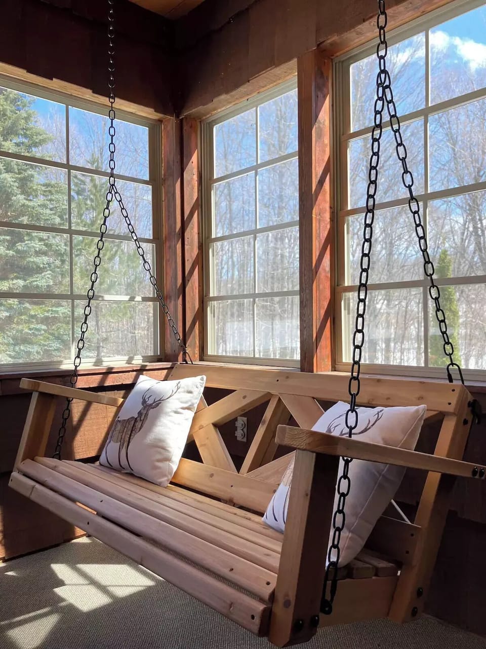 Curl up with your favorite book on the swing  seat in the three season room.