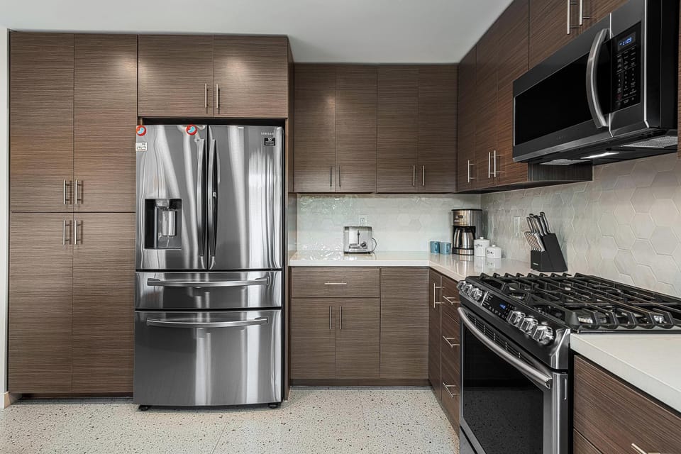 Ample sleek cabinets with large pantry, 5-burner gas range & built-in microwave