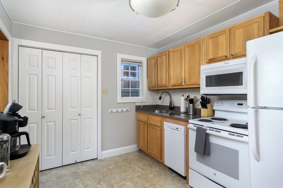 Kitchen with dishwasher & coffee station.