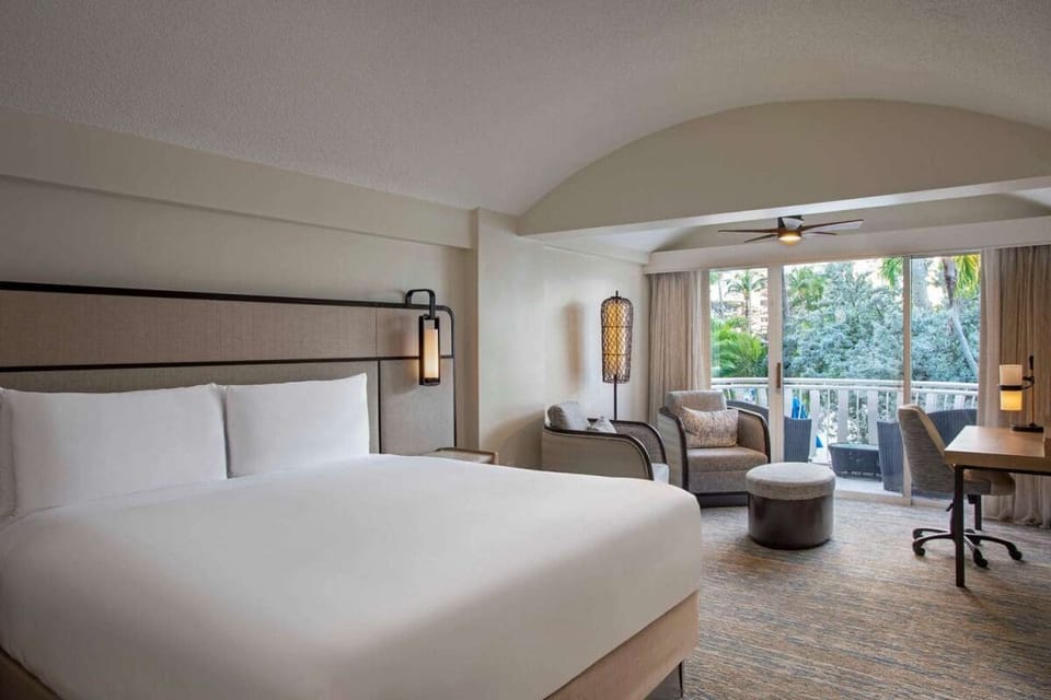 Drift off peacefully in a calm room with private balcony.