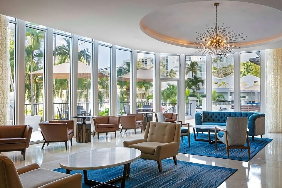 Relax in sunlit seating with breezy garden views outside.