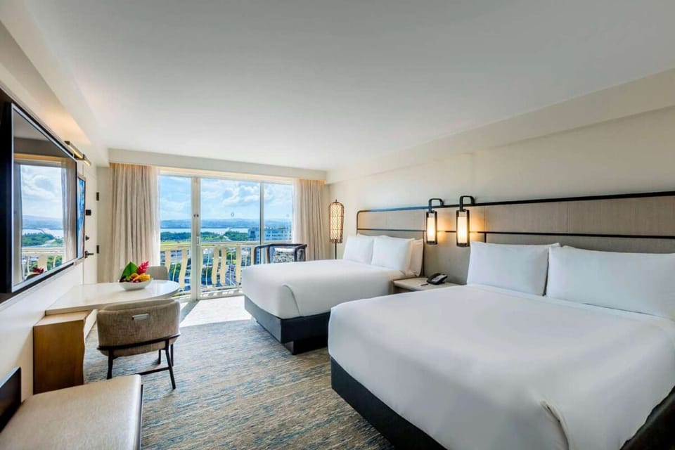 Breathe in island air with beds facing the balcony view.