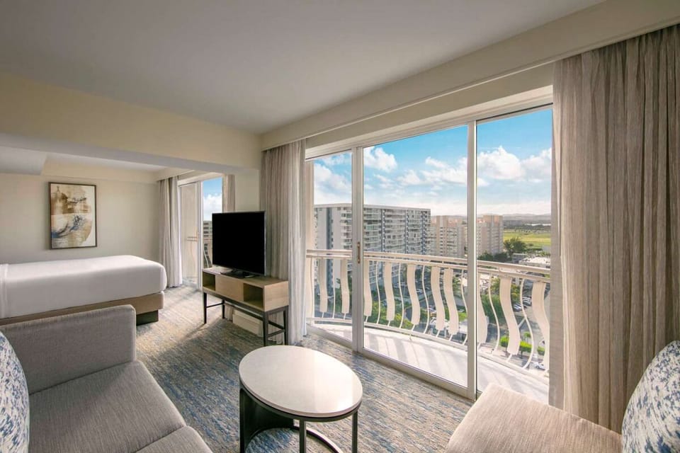 Sip coffee beside the balcony while the city sparkles.