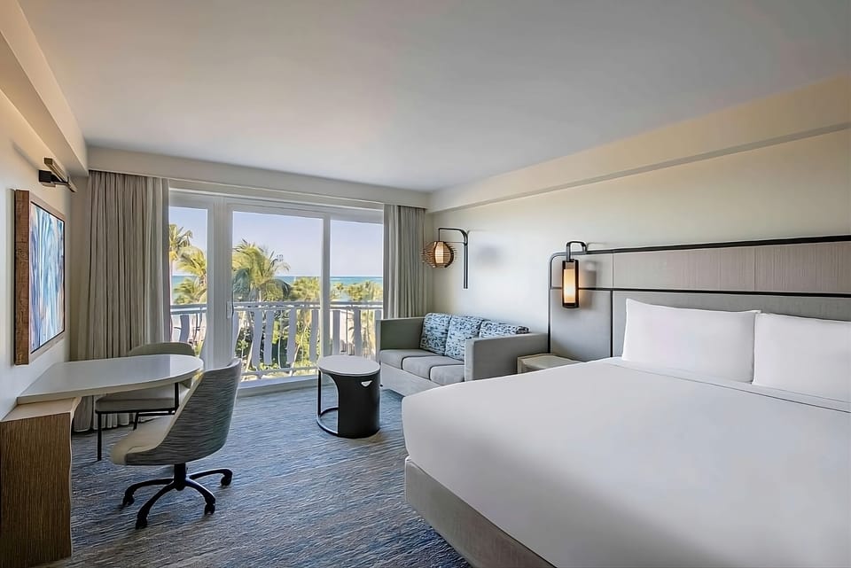 Wake up to turquoise water views from crisp white linens.