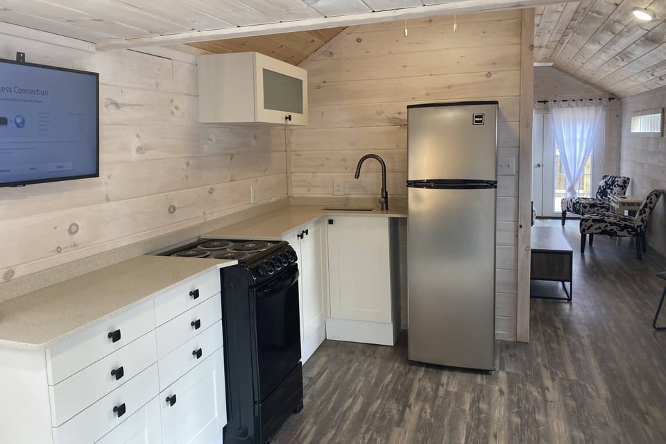 Fully stocked kitchen has ample dishes, glasses, silverware, bowls, pots and pans for quick food on the run or full meals.
