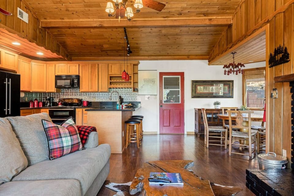 The home features vaulted wood T&G and open beam ceilings and large dual-pane windows.