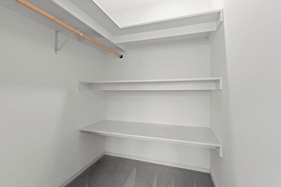 Spacious walk-in closet with shelving and hanging space, perfect for longer stays and keeping your space organized and clutter-free.