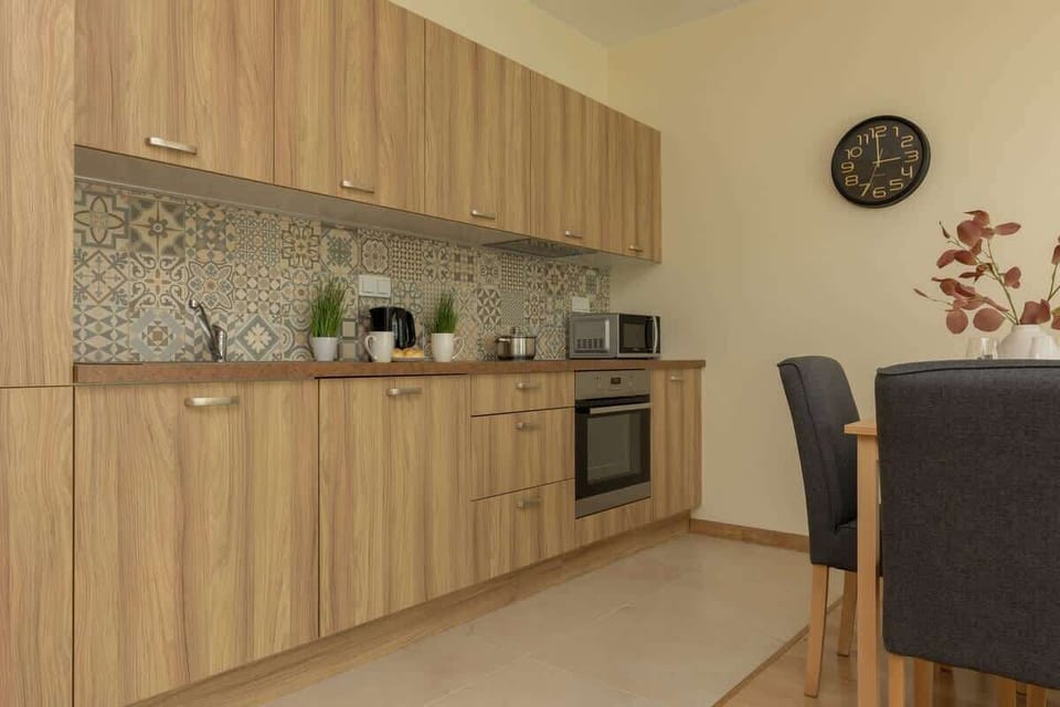 A close-up of the kitchen, featuring thoughtful details like herbs and a coffee setup.
